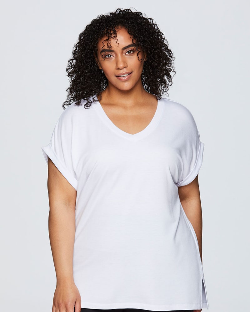 Front of a model wearing a size 1X Everyday V-neck Tunic in White by RBX Active. | dia_product_style_image_id:244788